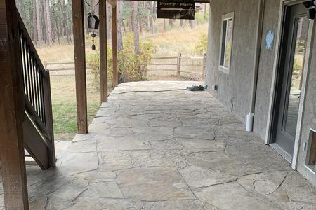 Flagstone patio in the back of a home in Perry Park Colorado
