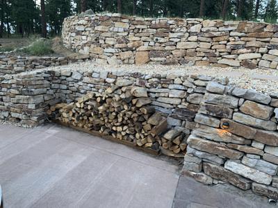 Siloam stone retaining wall in Monument Colorado with a place to store firewood out of the way