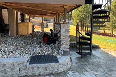 Clik to view full size Paver patio, veneer stoned deck pillars and a segmental retaining wall, changed the back yard view for this Monument, Colorado home