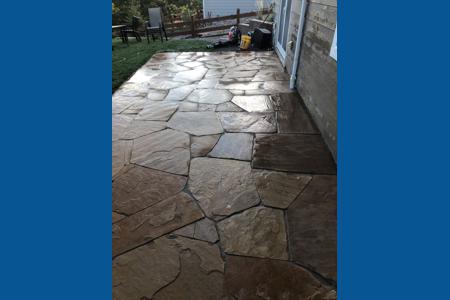 Flagstone patio in Monument, Colorado outside the lower level walk out to create more living space.