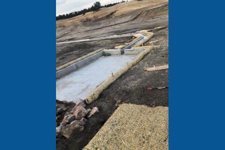 Clik to view full size Installed straw waddles along the trickle channel in Colorado Springs, Colorado