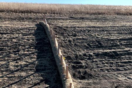 Installed straw waddles in a flow area that slows the water down and slows down the erosion but still allows water to flow in Black Forest, Colorado