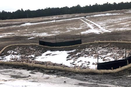 Clik to view full size Erosion control measures in place. Silt fence and waddles to slow the mud/silt down in Black Forest, Colorado