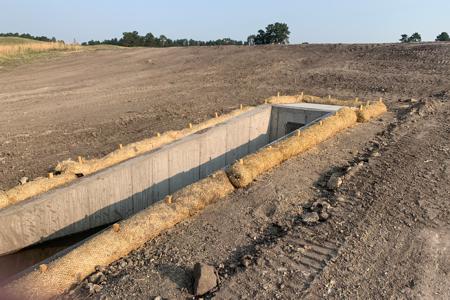Clik to view full size Straw waddles installed around outlet structure in Monument, Colorado