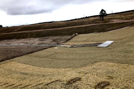 Erosion control in Black Forest, Colorado of the installation of erosion control blankets on the side of a slope so that the dirt does not get washed down and so that we can also get grass seeds to germinate