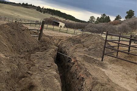 Clik to view full size Installing a water line in a pasture in Larkspur, Colorado