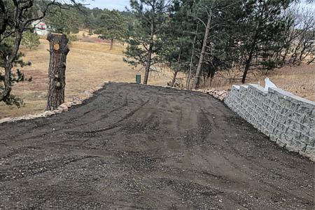 Clik to view full size Installed a segmental retaining wall and a crushed asphalt driveway in Monument, Colorado