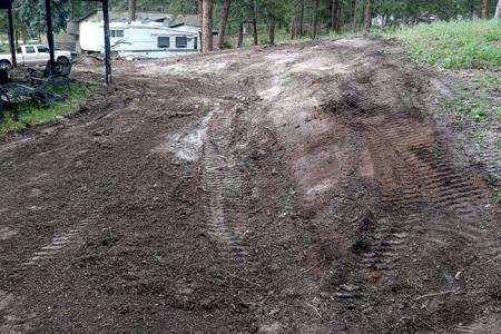 Clik to view full size Excavating around a barn to divert water away and allow access around the barn in Black Forest, Colorado