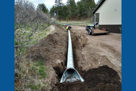 Culvert installation in Larkspur, Colorado for water to drain away from the barn and to control the erosion.