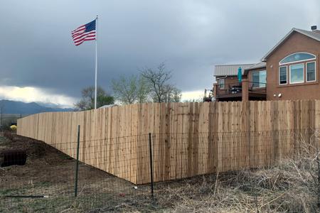 Clik to view full size Privacy fence with Old Glory beautifully positioned in the background at a home in El Paso county Colorado