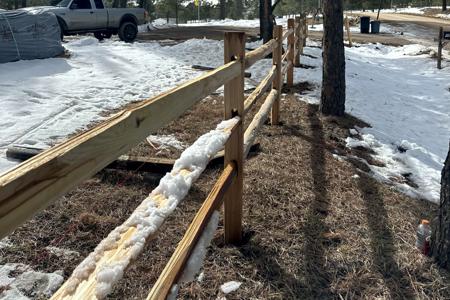 Split rail fence in Black Forest, Colorado with wire installed on the inside to keep the dogs contained to their 5 acres