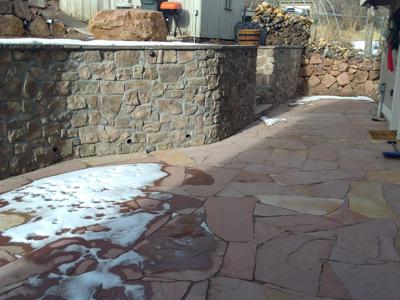 Click to view full size Veneer stoned retaining wall with veneer stoned stairs in Palmer Lake Colorado