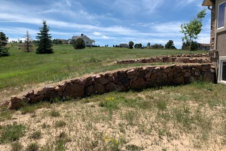 Click to view full size Pioneer granite retaining walls in Monument, Colorado for directing of water and for erosion control