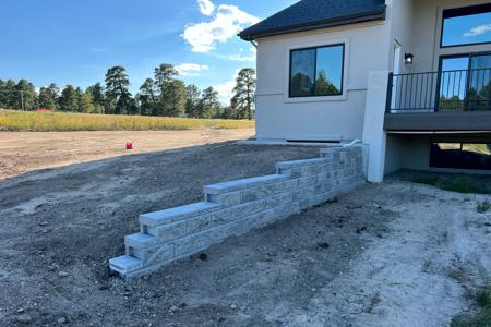 Segmental retaining wall installed in Black Forest, Colorado to keep the water flowing away from the home and allow more flat open space behind the home.