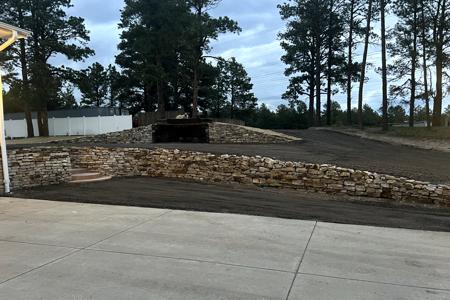 Siloam Stone retaining wall installed in Black Forest, Colorado to act as a retaining wall on the lower section for additional parking, upper Siloam stone wall was built to create RV parking and short hand gun range installed with AR plate