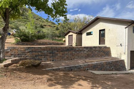 Retaining wall in Palmer Lake, Colorado. Installed a series of retaining walls for this home to have more flat parking, erosion control, concrete hot tub pad and more useable space