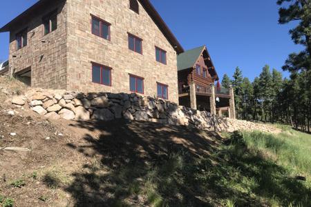 Click to view full size Boulder retaining wall for an RV parking behind a home in Woodmoor Mtn Colorado