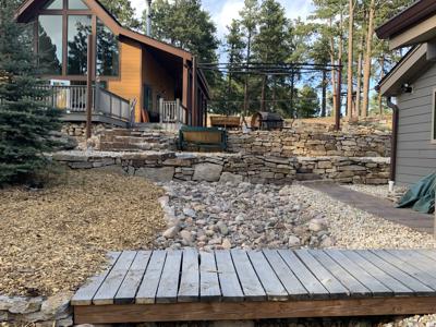 Click to view full size Siloam stone retaining wall, root cellar entrance, stairs leading up to second tier in Monument Colorado