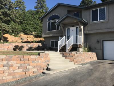 Click to view full size Segmental retaining wall with concrete stairs in Palmer Lake Colorado